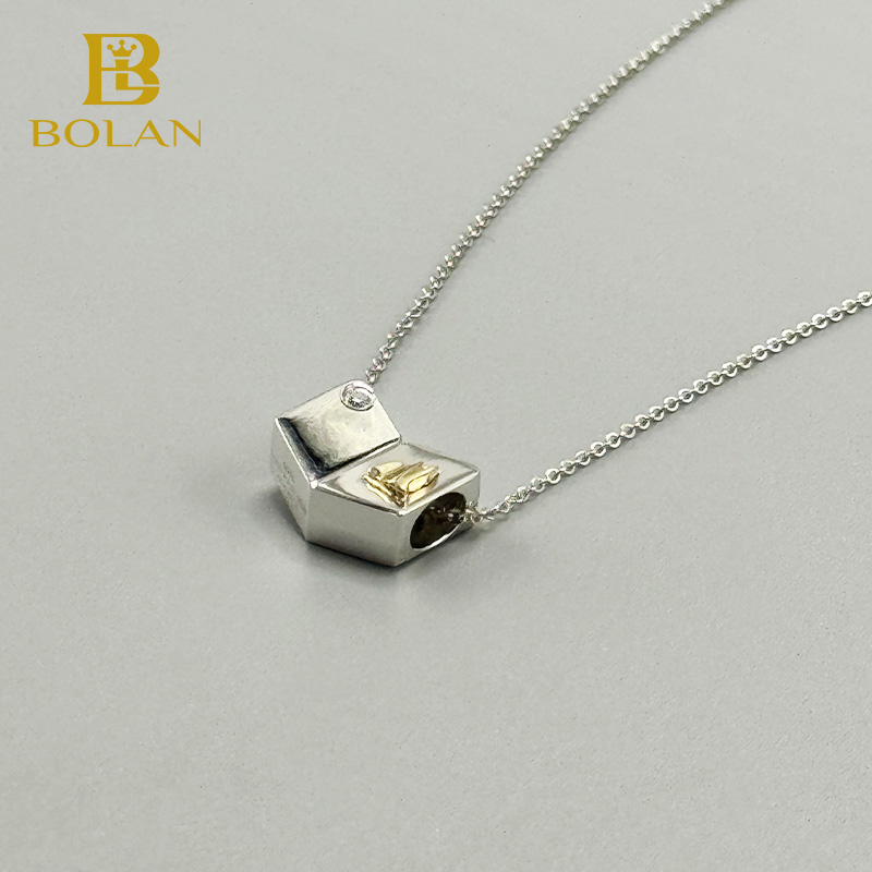 Book pendant in platinum with 18K gold setting
